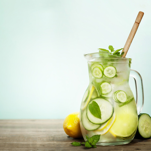 Infused water with cucumber, lemon, lime and mint  - Fotoğraf, Görsel