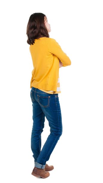 back view of standing young beautiful  brunette woman in yellow - Foto, immagini