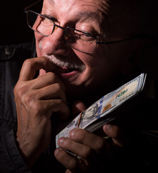 Sly senior man holding dollar bills - Photo, Image