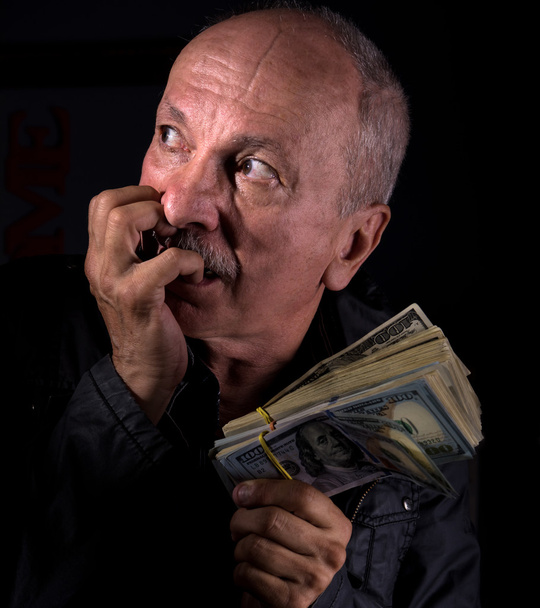 Sly senior man holding dollar bills - Photo, Image