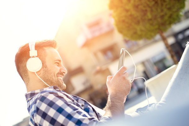 Young man with headphones enjoying the music - Photo, Image