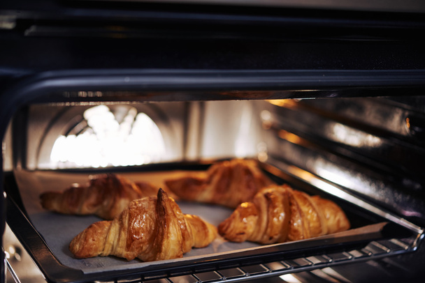 crispy tasty croissants in oven - Photo, Image