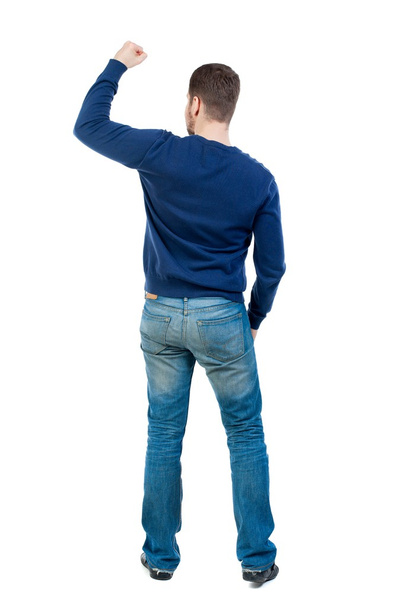 Back view of  man.  Raised his fist up in victory sign. - Фото, изображение