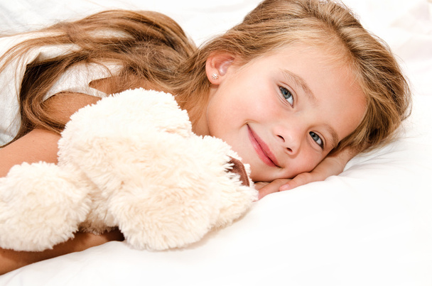 Adorable smiling little girl waked up  - Foto, afbeelding
