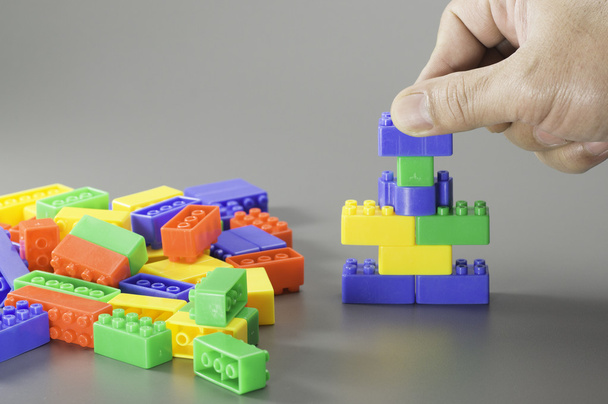 Brick toy and hand - Fotó, kép