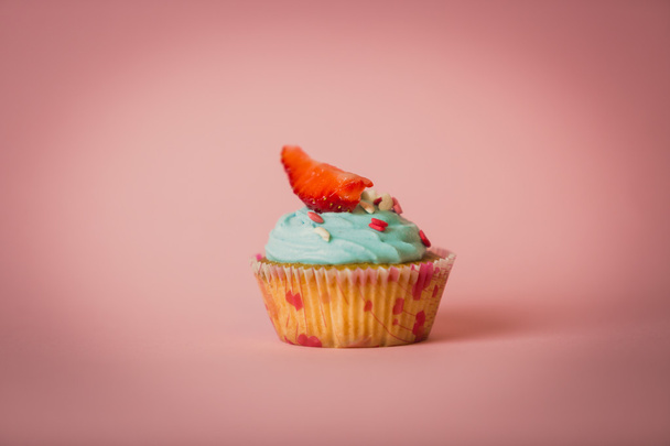 Toned photo of cupcake with buttercream decorated with sprinkles - Fotografie, Obrázek