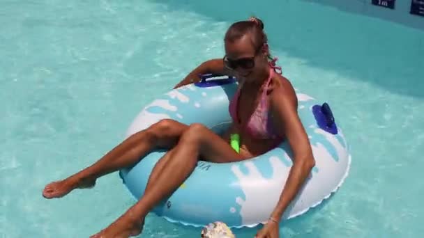 Mother having fun with little girl in the pool. - Video