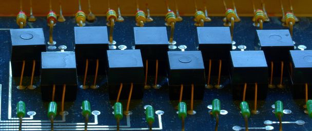 Condensers, relays assembly on the circuit board. Macro image. Shallow DOF.  - Photo, Image