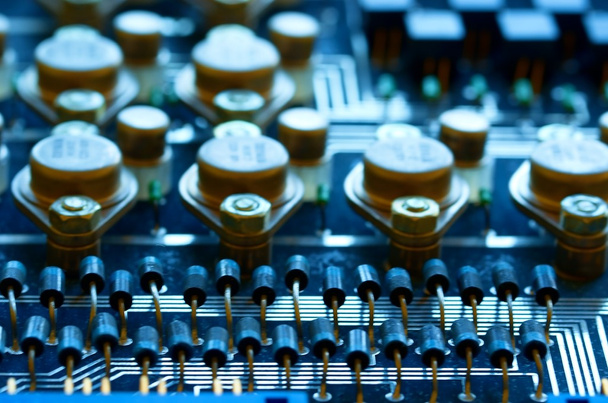 Condensers, relays assembly on the circuit board. Macro image. Shallow DOF.  - Photo, Image