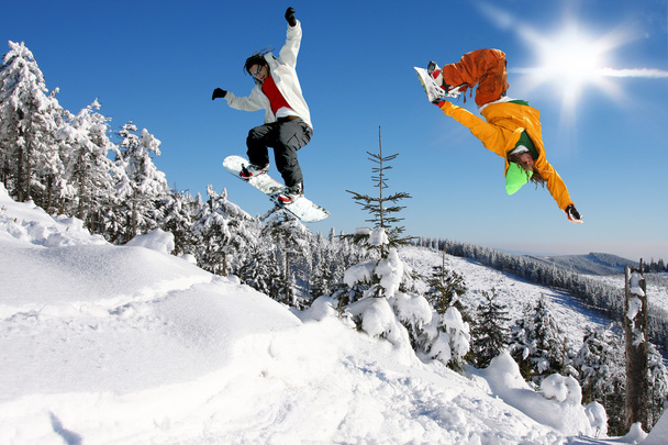 Snowboarders saltando contra el cielo azul
 - Foto, Imagen