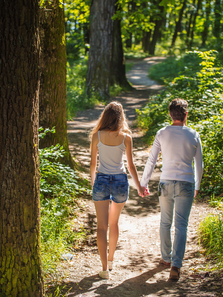young couple walking in forest - Foto, afbeelding