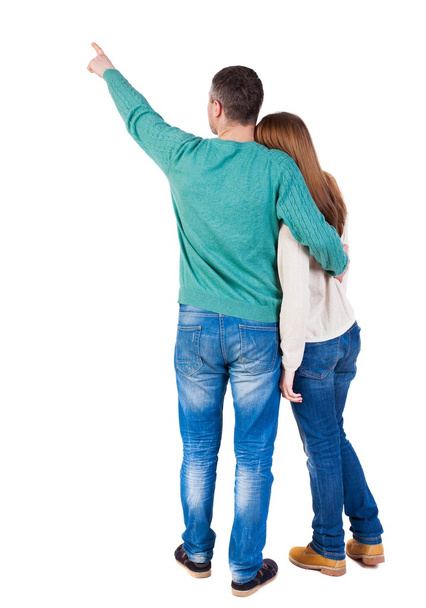 young couple pointing at wal Back view - Foto, imagen