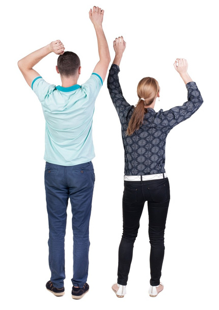Back view of  joyful couple celebrating victory hands up. - Photo, image