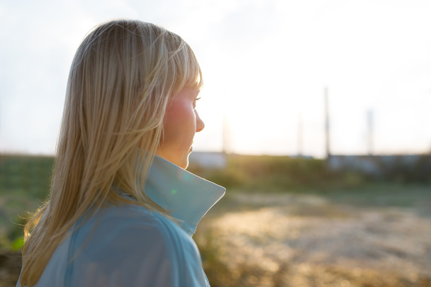 Portrait of a beautiful blonde woman close-up at sunset - Фото, изображение