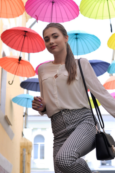 Girl posing under colorful umbrellas - Фото, зображення
