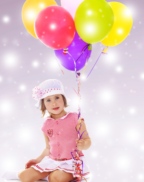 Girl holding balloons - Фото, зображення