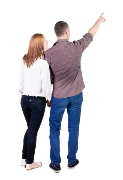 young couple pointing at wal Back view - Foto, immagini