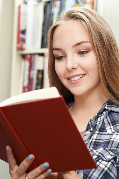 Teenage Girl Reading Book At Home - Valokuva, kuva
