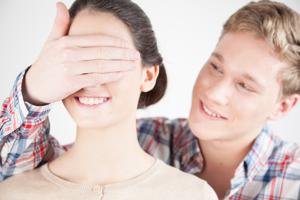 Happy boy covering girl's eyes by hand   - Photo, Image