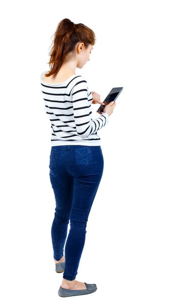 back view of standing young beautiful  woman using a mobile phon - Zdjęcie, obraz