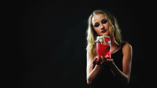 St. Valentines Day. A girl holding a glass jar with a red heart inside. - Footage, Video