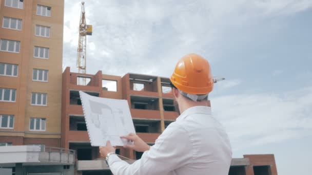 Architect looking at blueprints at a building site. - Footage, Video