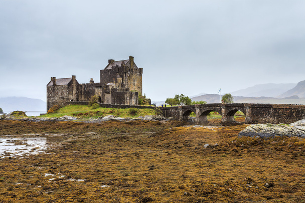 Замок Эйлан Донан на низких водах Шотландии
 - Фото, изображение