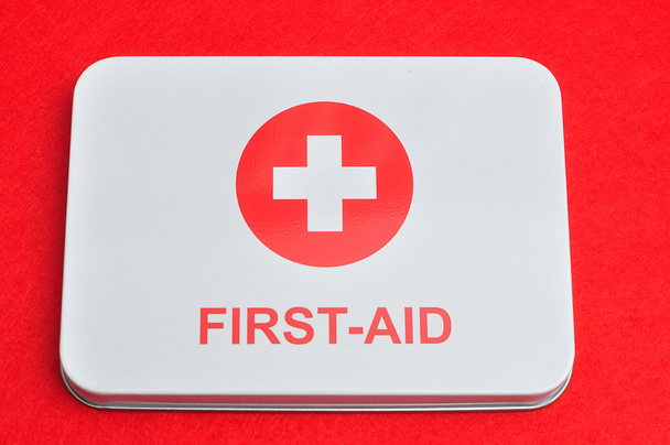 First aid sign isolated against a red background - 写真・画像