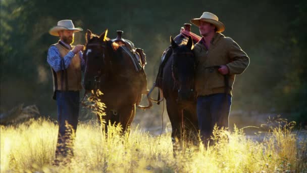 Cavaleiros de vaqueiro com cavalos em montanhas rochosas
 - Filmagem, Vídeo