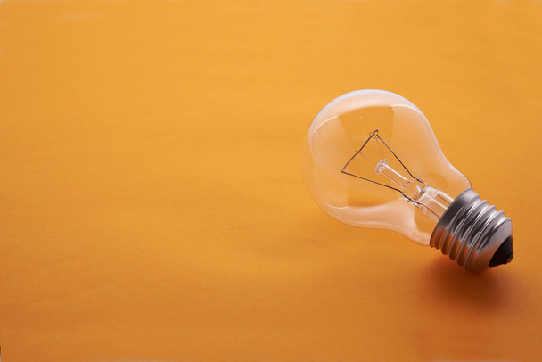 light bulb on a yellow background - Photo, Image