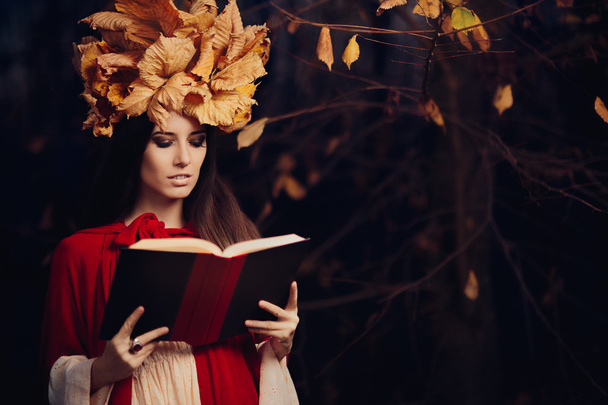 Woman With Autumn Leaves Crown Reading a Book - Фото, зображення