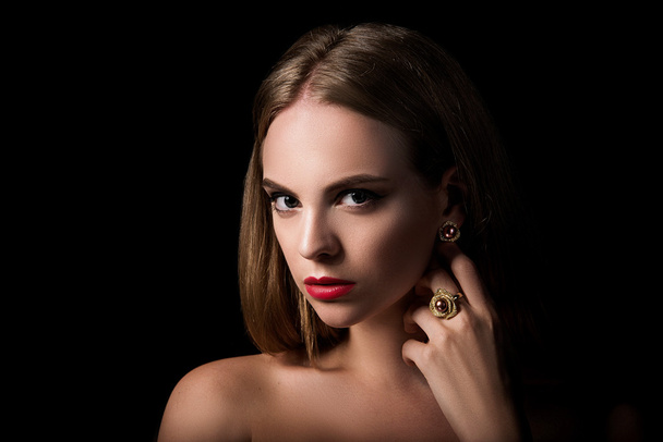 Beauty portrait of blond girl with jewelry on black background - Фото, зображення