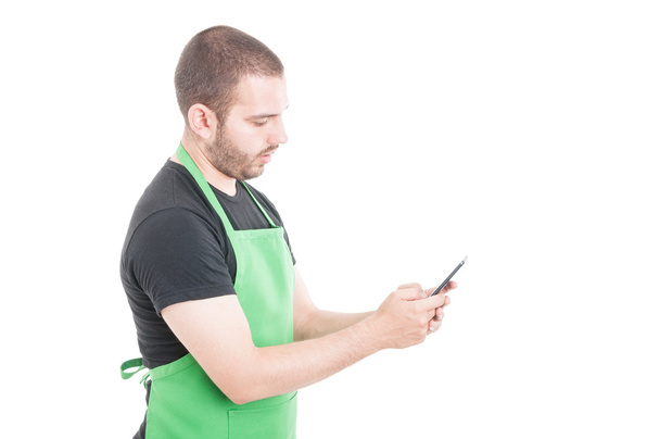 Hypermarket seller texting on smartphone - Photo, Image