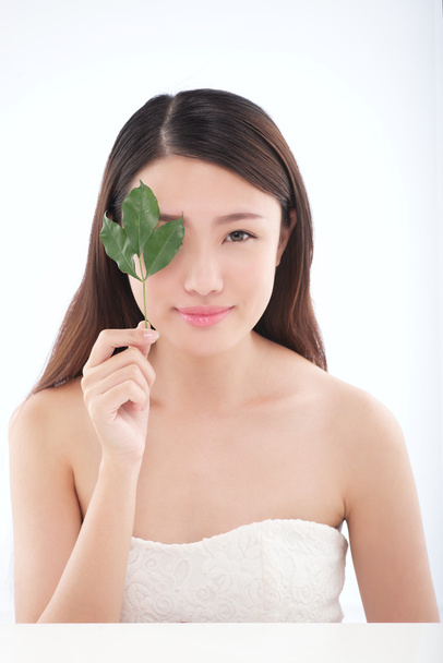 woman with green leaf - Фото, изображение