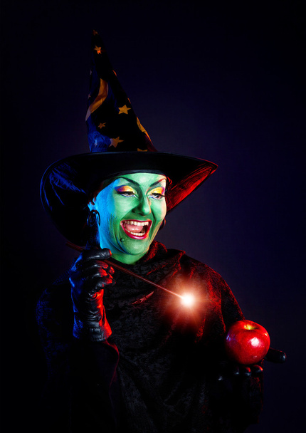 Wicked witch doing magic with her wand  - Foto, Imagen