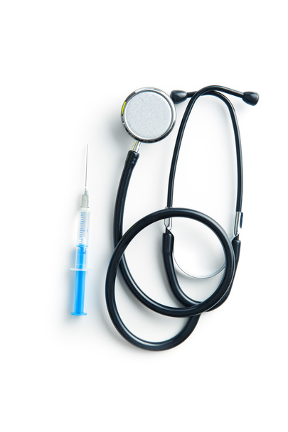 Stethoscope and syringe. - Zdjęcie, obraz