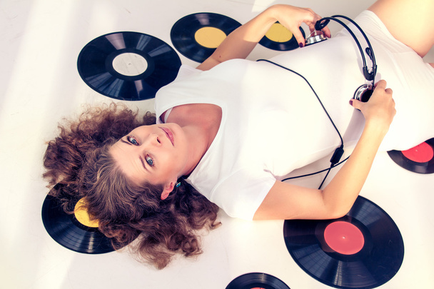Woman listens to music through headphones. - Foto, imagen