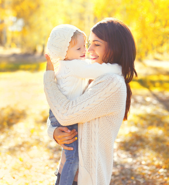 Portrait happy smiling mother hugging child having fun in warm s - Photo, Image