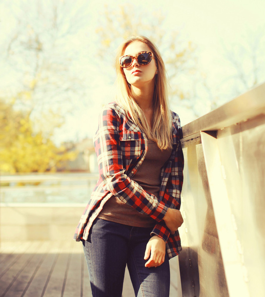 Fashion pretty woman wearing a sunglasses and checkered shirt in - Photo, Image