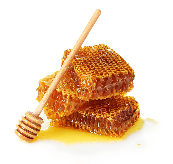 Sweet honeycomb and wooden drizzler, isolated on white - Фото, изображение