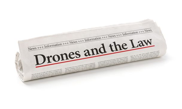 Periódico enrollado con el titular Drones y la Ley
 - Foto, Imagen