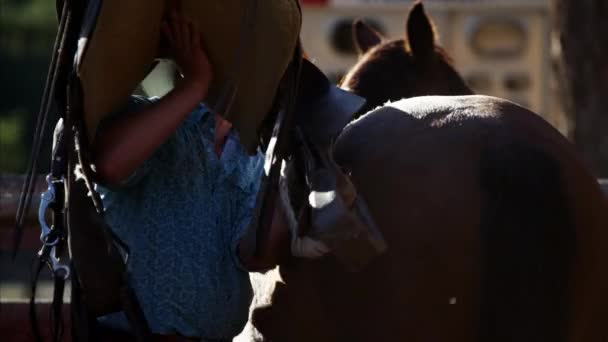 Cowboys in corral saddling horse - Footage, Video