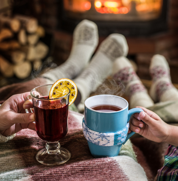 Warming and relaxing near fireplace with a cup of hot drink. - Foto, immagini