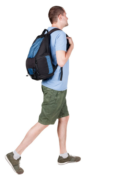 back view of walking  man  with backpack. - Foto, afbeelding