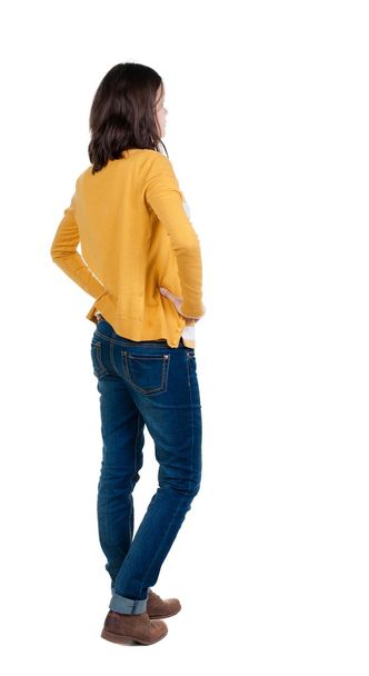 back view of standing young beautiful  brunette woman in yellow - Foto, Imagen