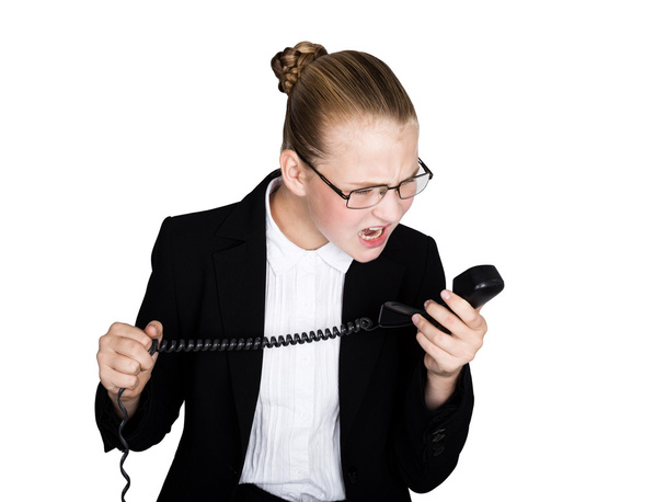 Little business woman talking on a phone, screaming into the phone. Studio portrait of child girl in business style. isolated on a white background. - Foto, Imagen