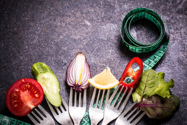 Fresh mixed vegetables on fork ,black background - Foto, Bild