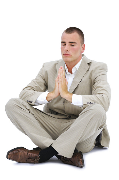 Junger Mann meditiert im Büro isoliert auf Weiß - Foto, Bild
