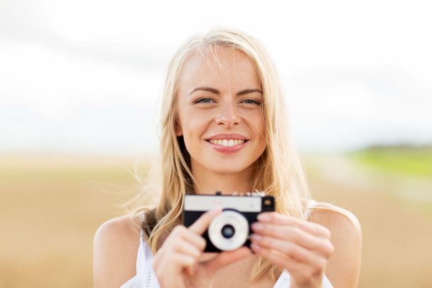happy young woman with film camera outdoors - Фото, изображение