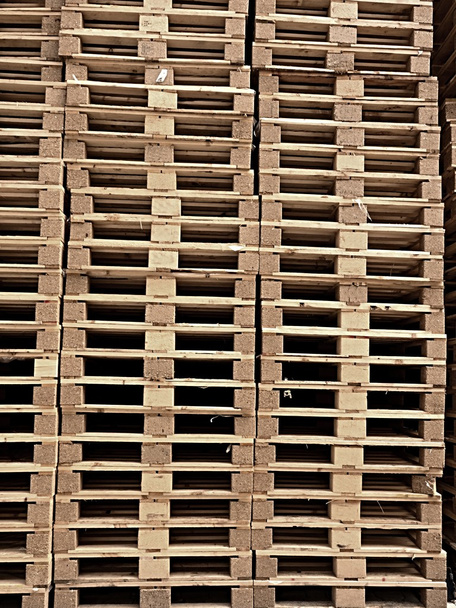 Stock Piles of wooden pallets in a yard ready for breaking up and recycling into firewood or kindling - Fotó, kép